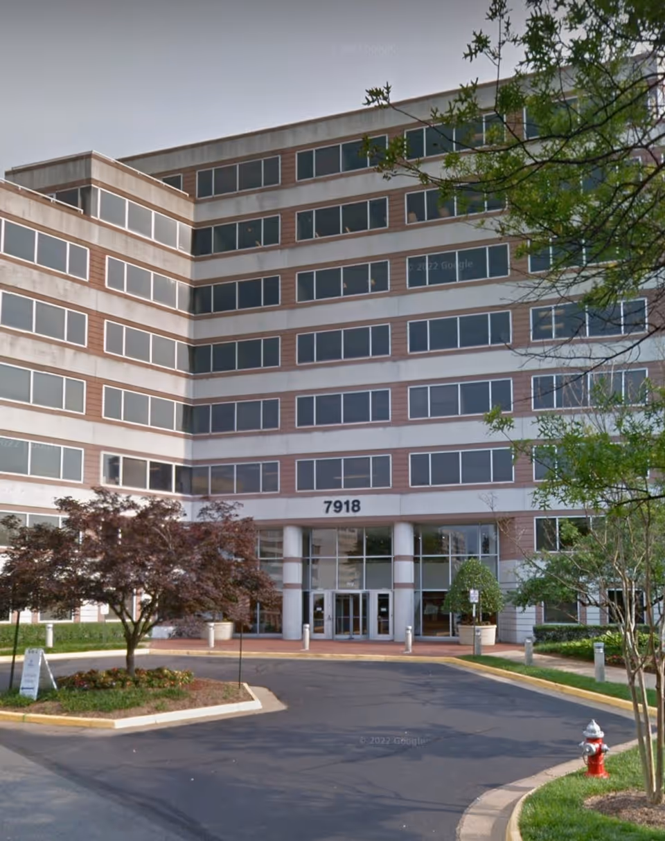 Exterior view of a multi-story senior living building with a main entrance and landscaping