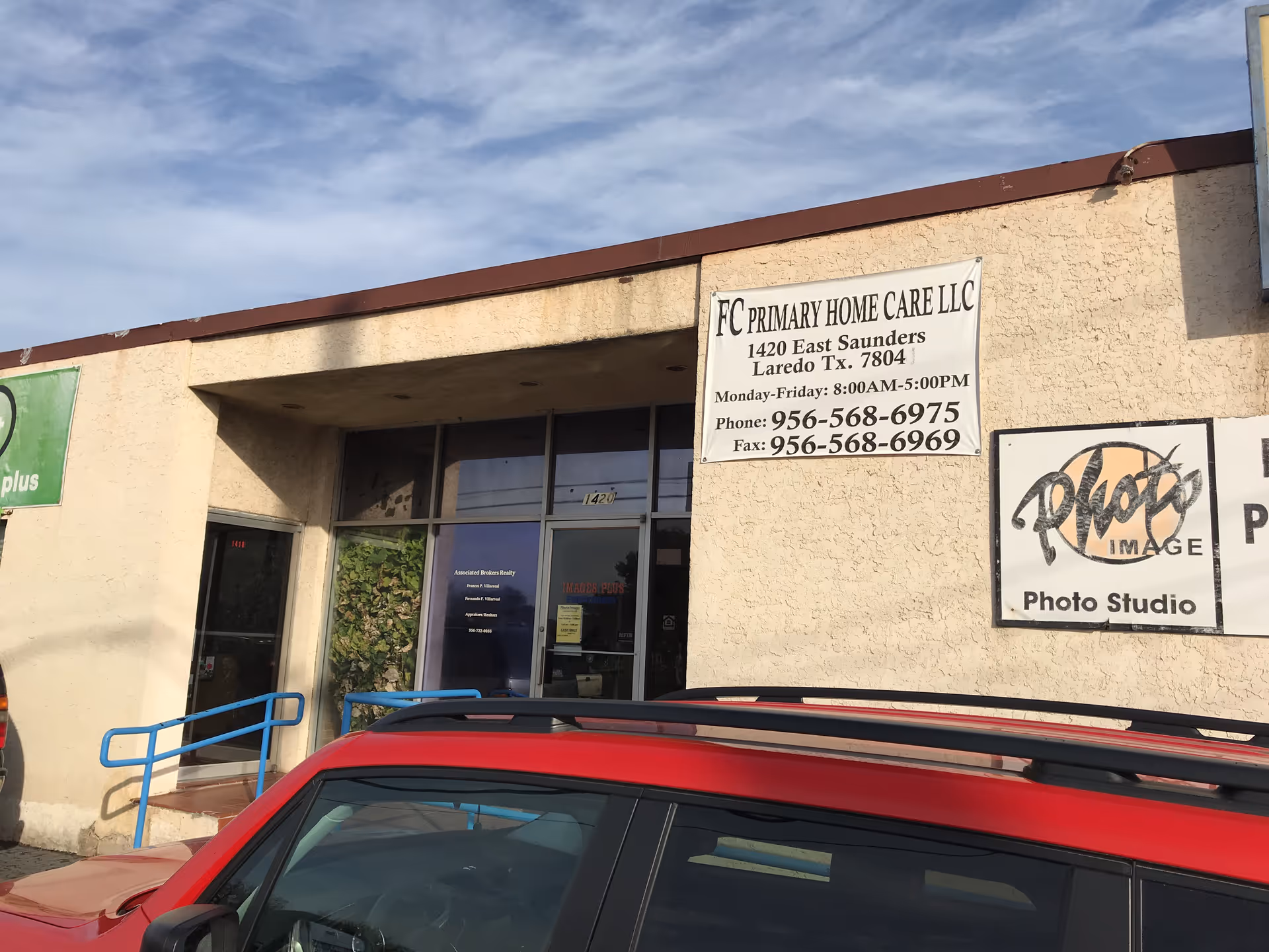 Exterior front of FC Primary Home Care LLC with signs and a parked car