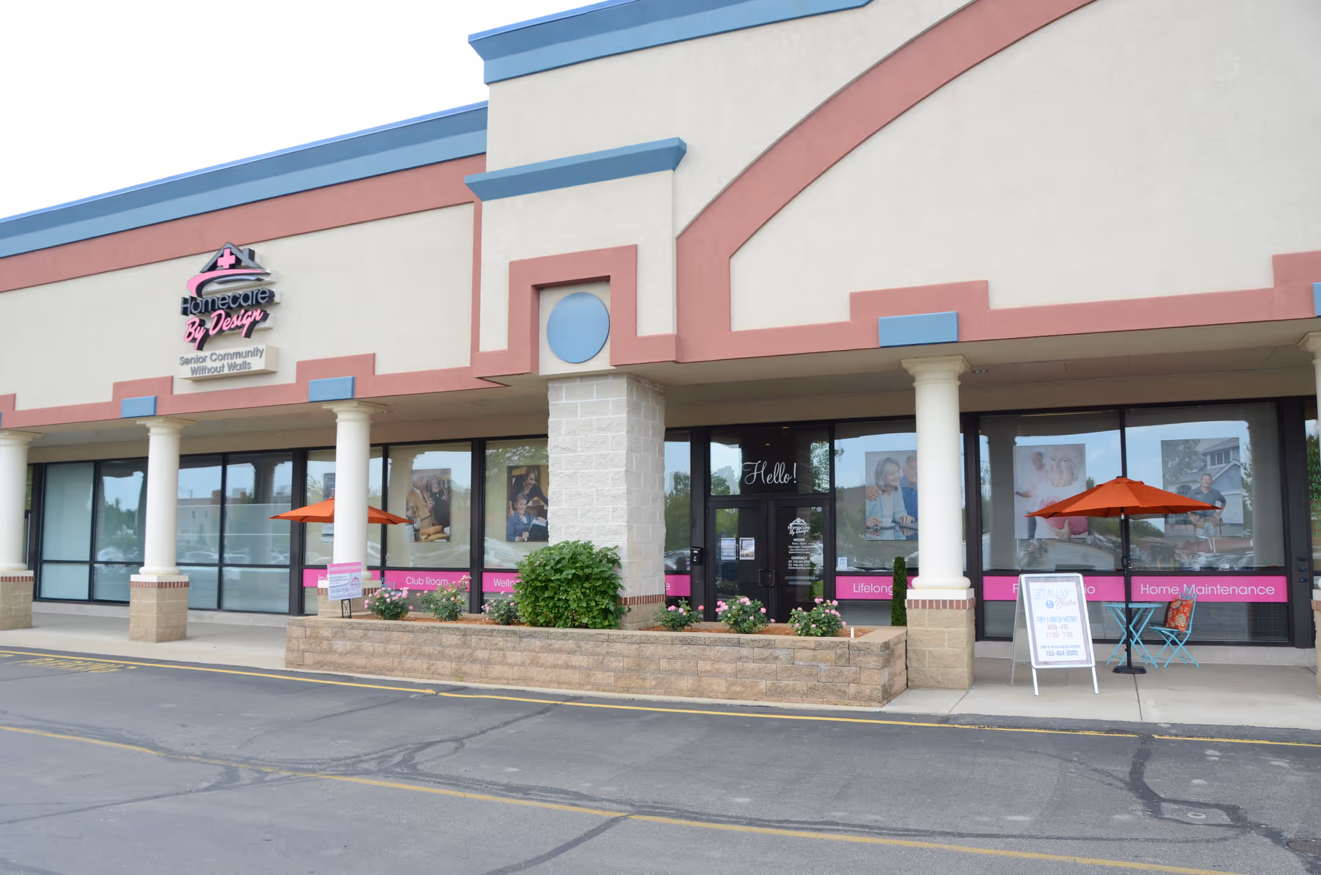 Exterior view of a senior living facility storefront with columns and signage.