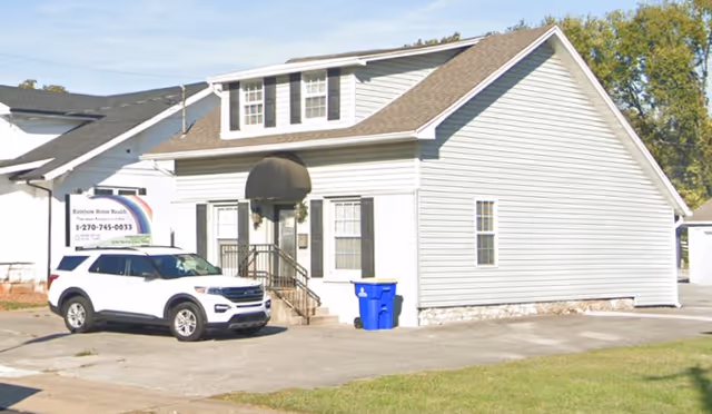 Exterior of Rainbow In Home Personal Care building with a white van parked outside