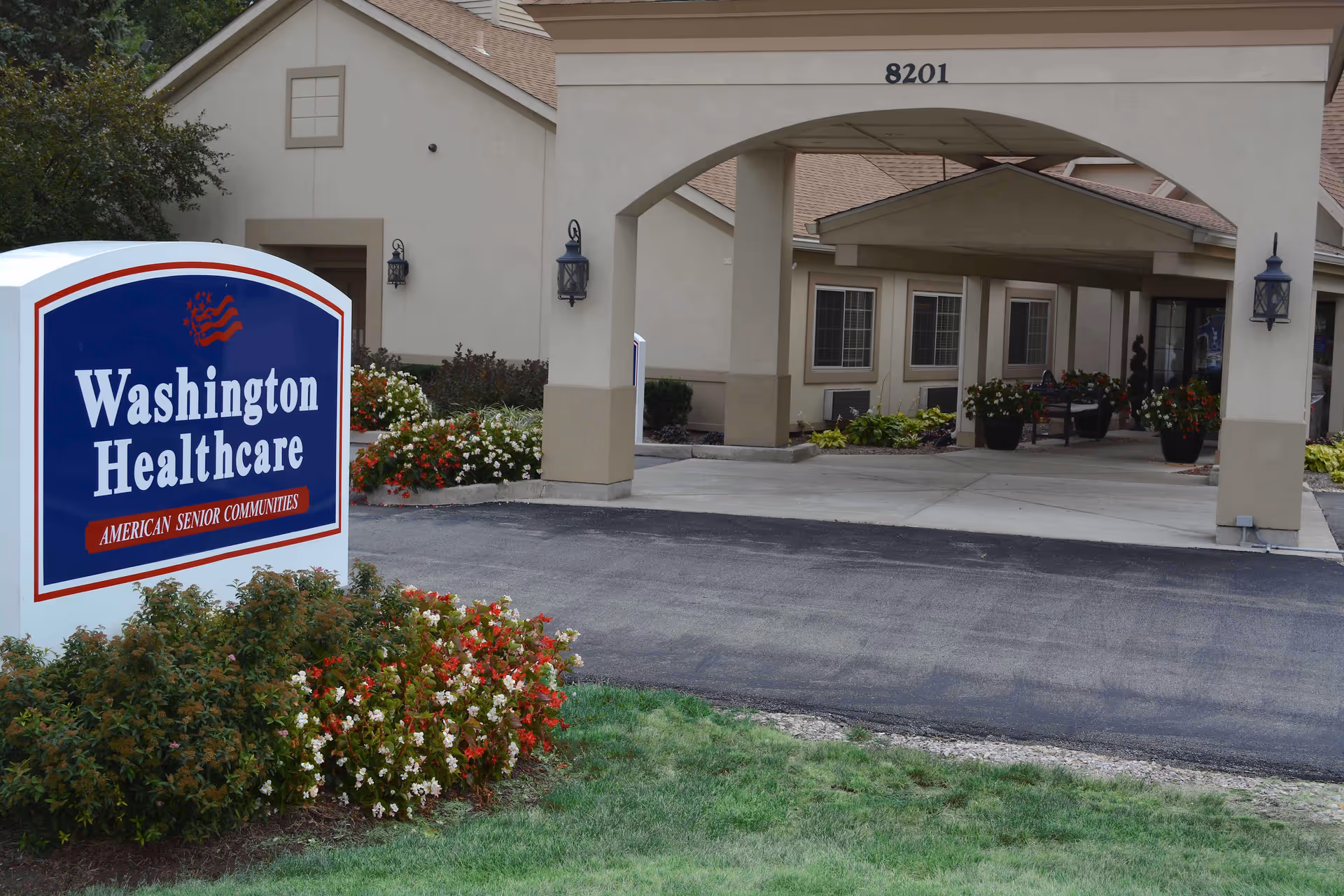 Front view of Washington Healthcare Center with sign and welcoming entrance arch