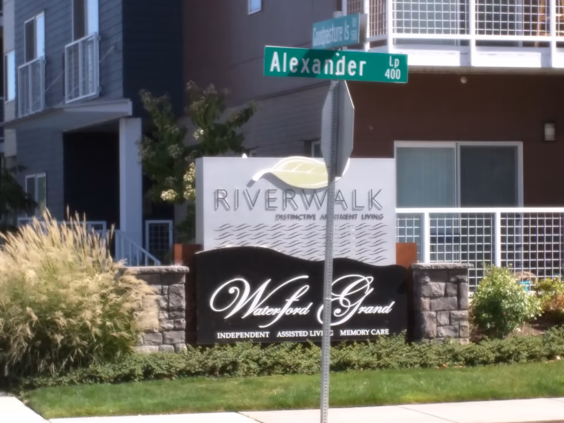 Exterior view of Waterford Grand entrance with Riverwalk sign and Alexander Street street sign