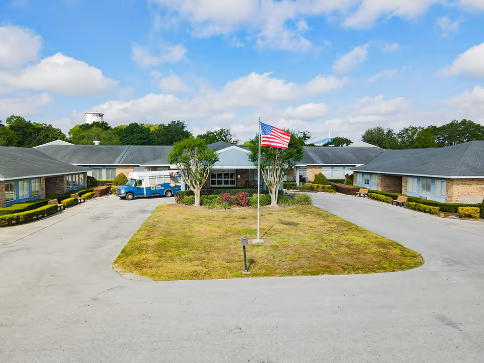 Exterior view of Adventhealth Care Center Zephyrhill North with a central flagpole and driveway.