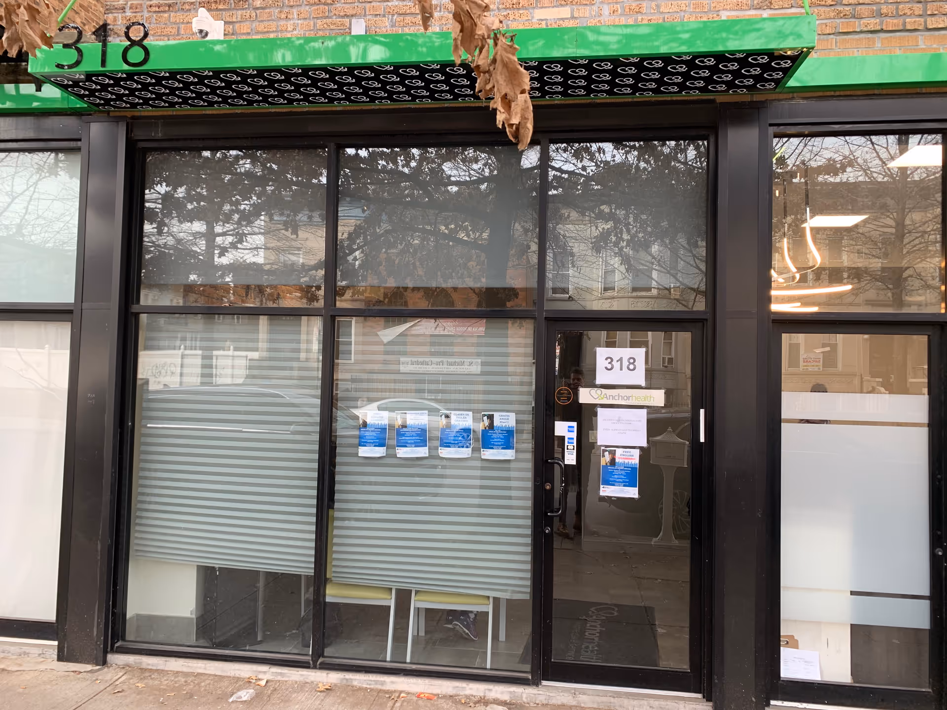Exterior storefront of Anchor Health Home Care with glass doors and a green awning.
