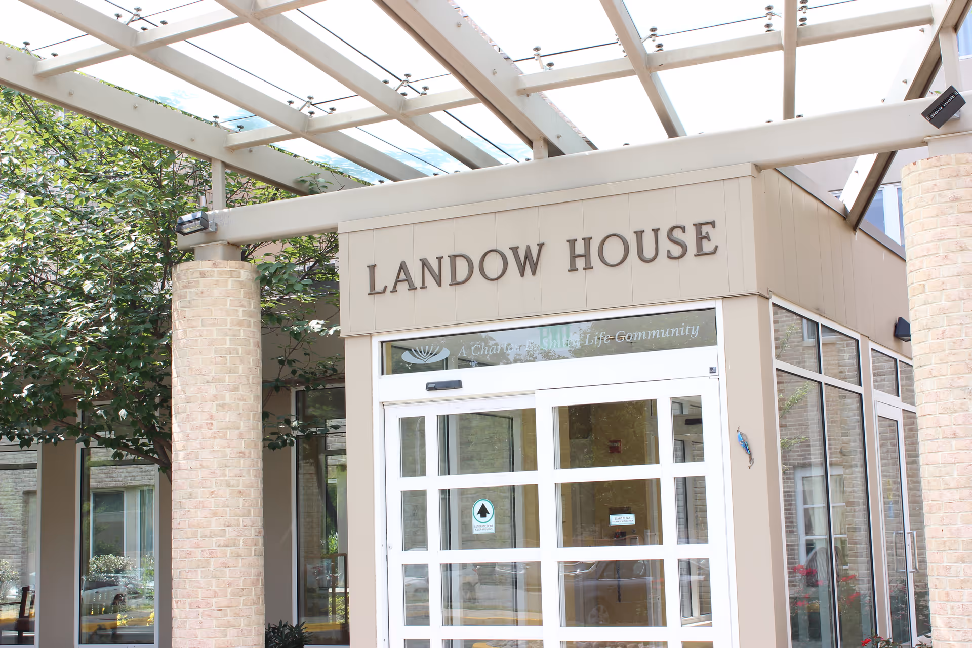 Exterior view of Landow House entrance with glass doors and signage.
