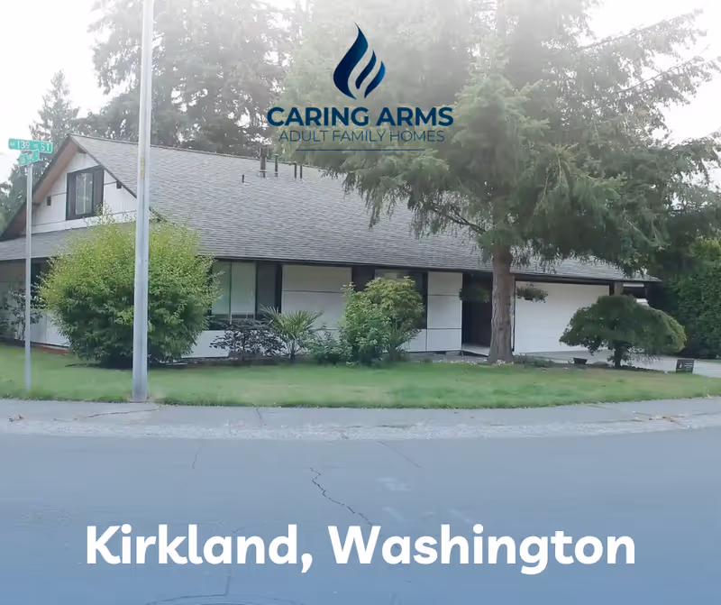 Exterior view of a single-story Caring Arms Adult Family Home with lawn, trees, and street.