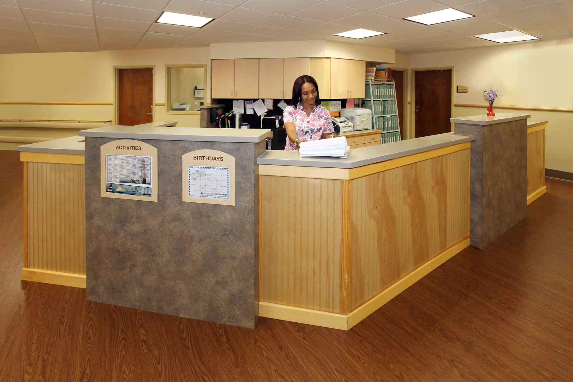 Reception desk at Granville Center for Rehabilitation and Nursing lobby with a staff member.