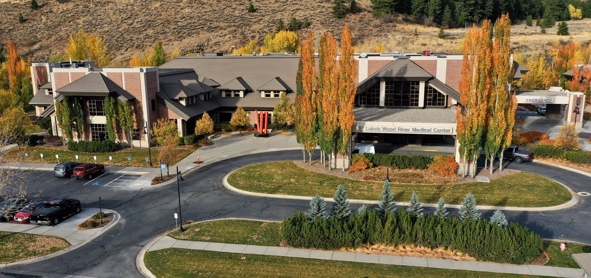 Aerial view of St. Luke's Wood River Medical Center exterior, with driveway, parking, and autumn trees.