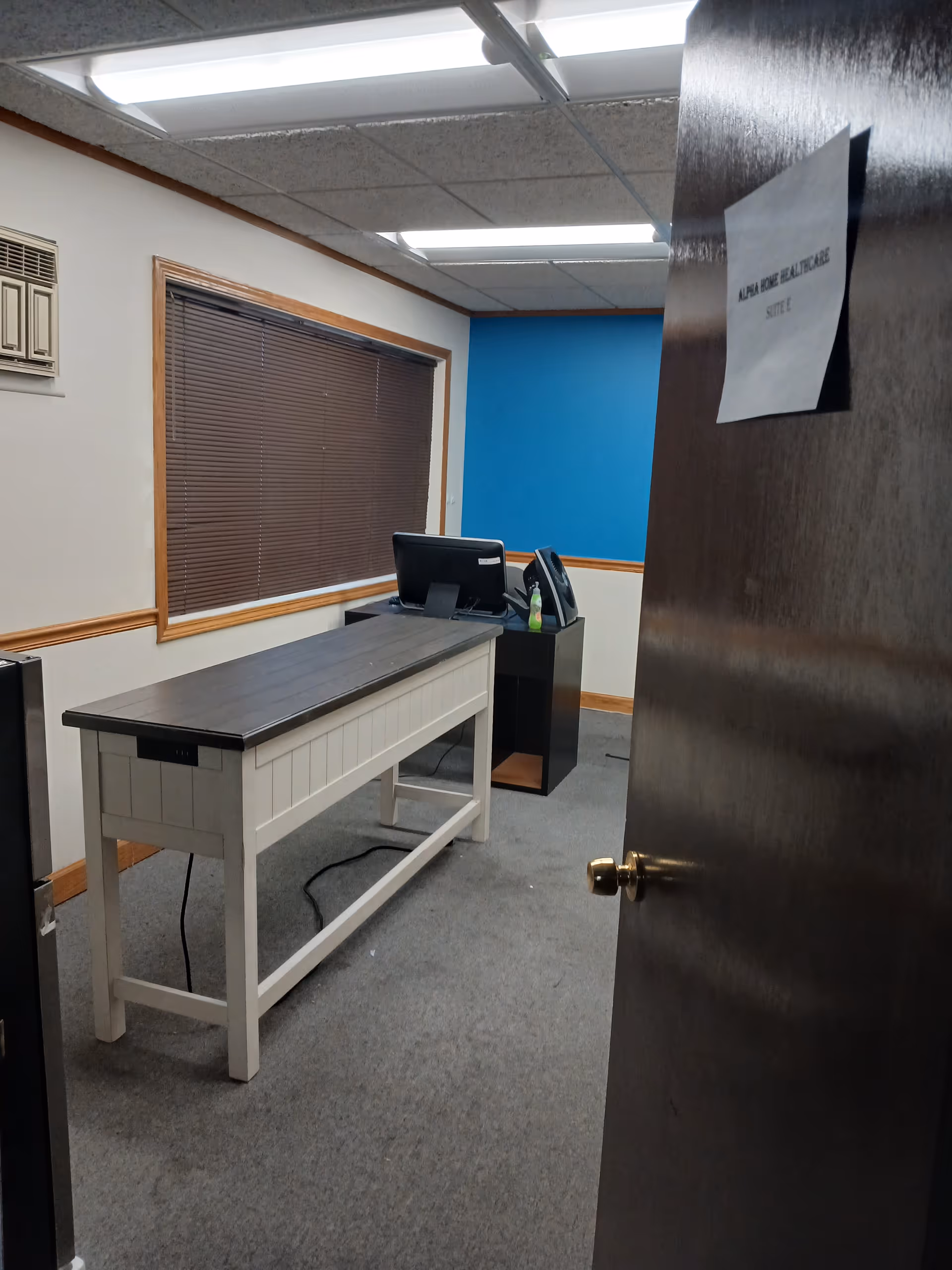 Office reception area inside Alpha Home Health Care with a desk and computer.