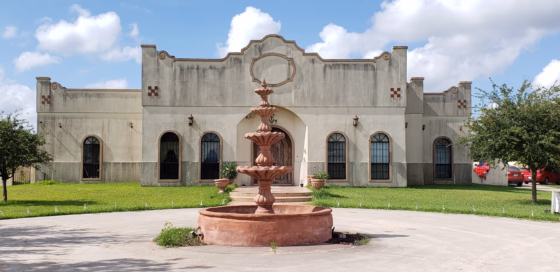 Exterior view of Hacienda Health Care facility with a large fountain in front