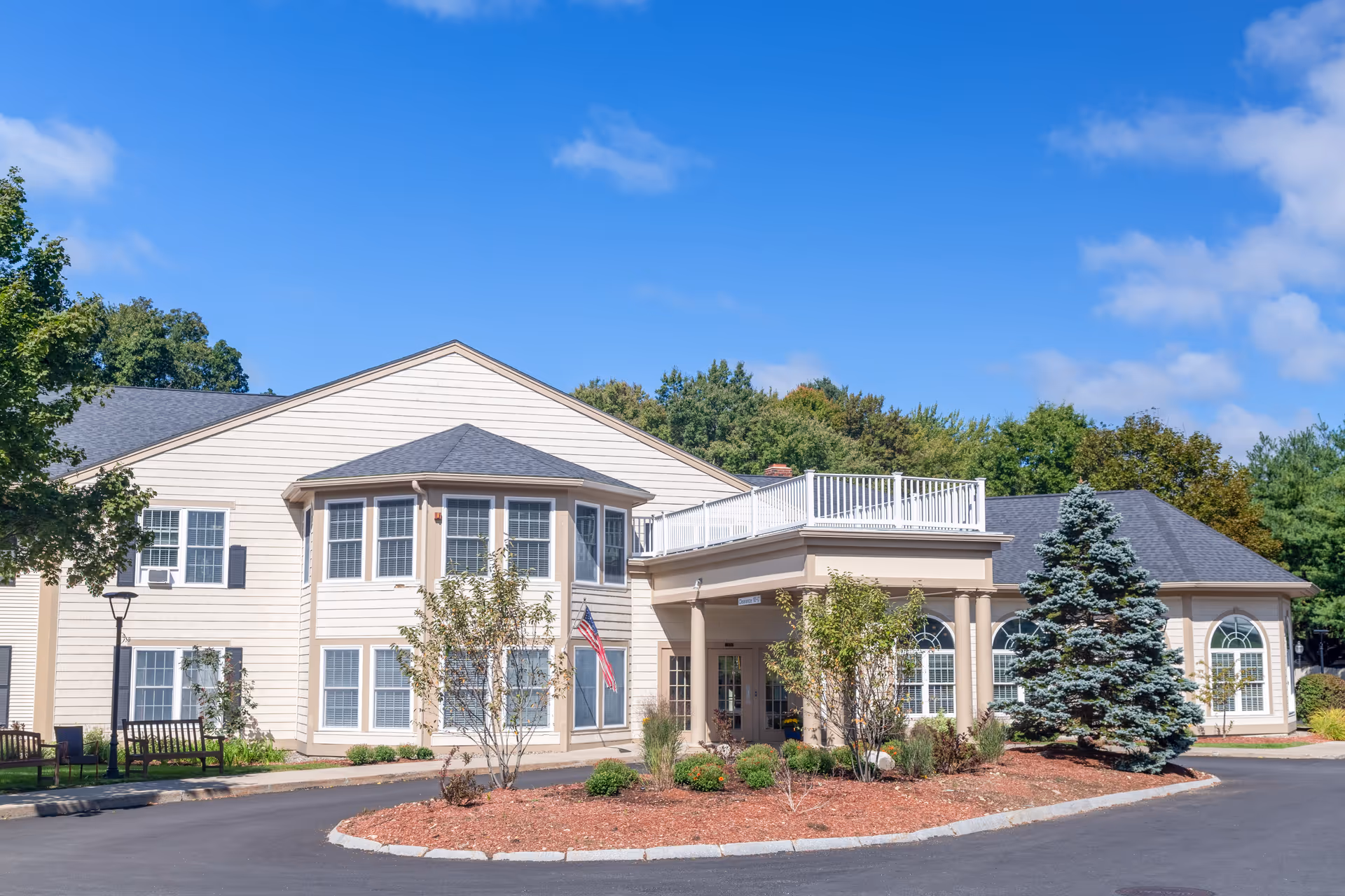 Front exterior of Benchmark Senior Living at Shrewsbury Crossings with entrance and landscaping.