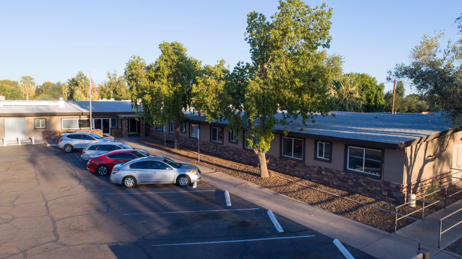 Exterior view of Desert Terrace Healthcare Center with a parking lot and landscaped front.