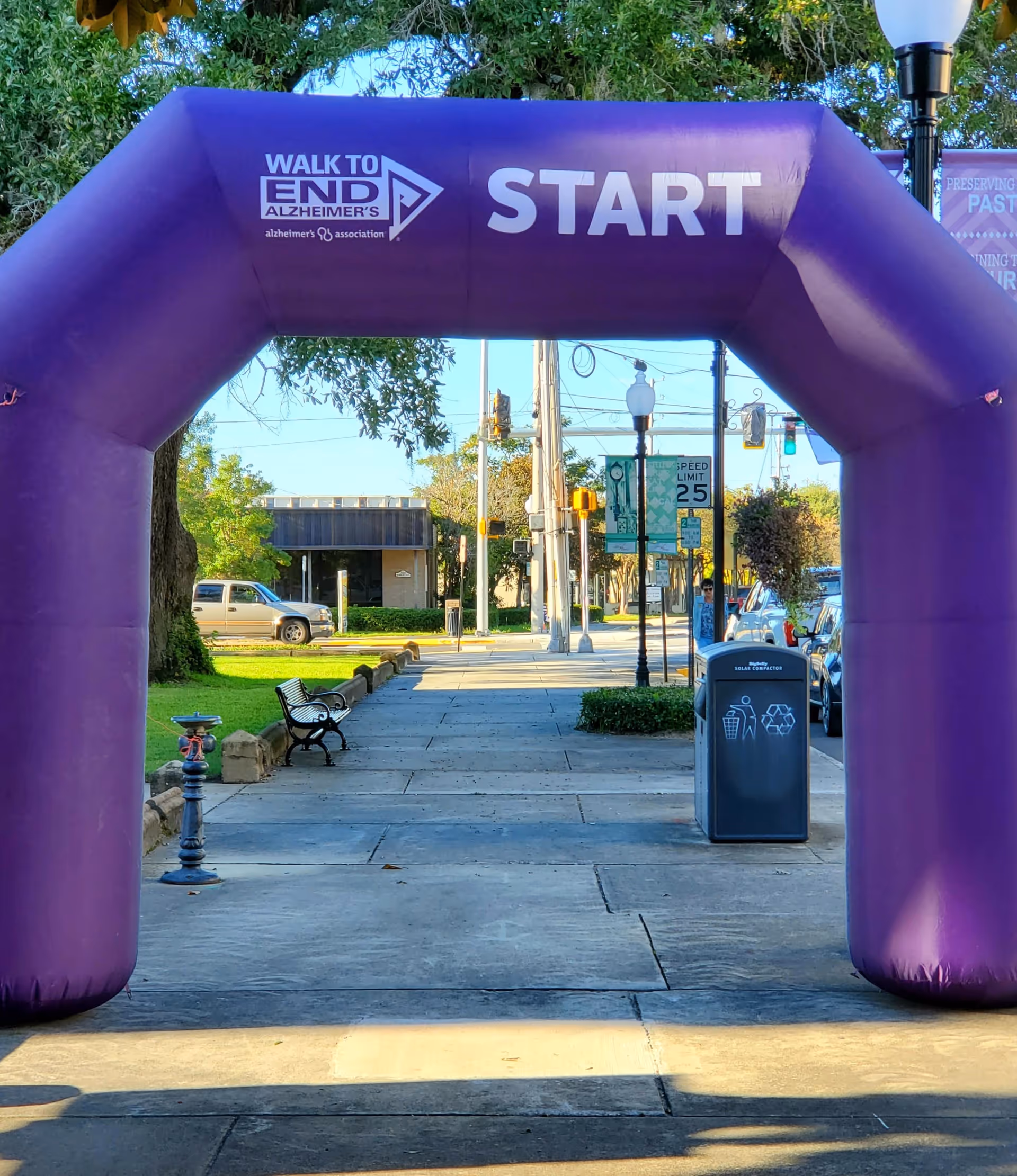Purple inflatable START arch spans a sidewalk for Walk to End Alzheimer's event.