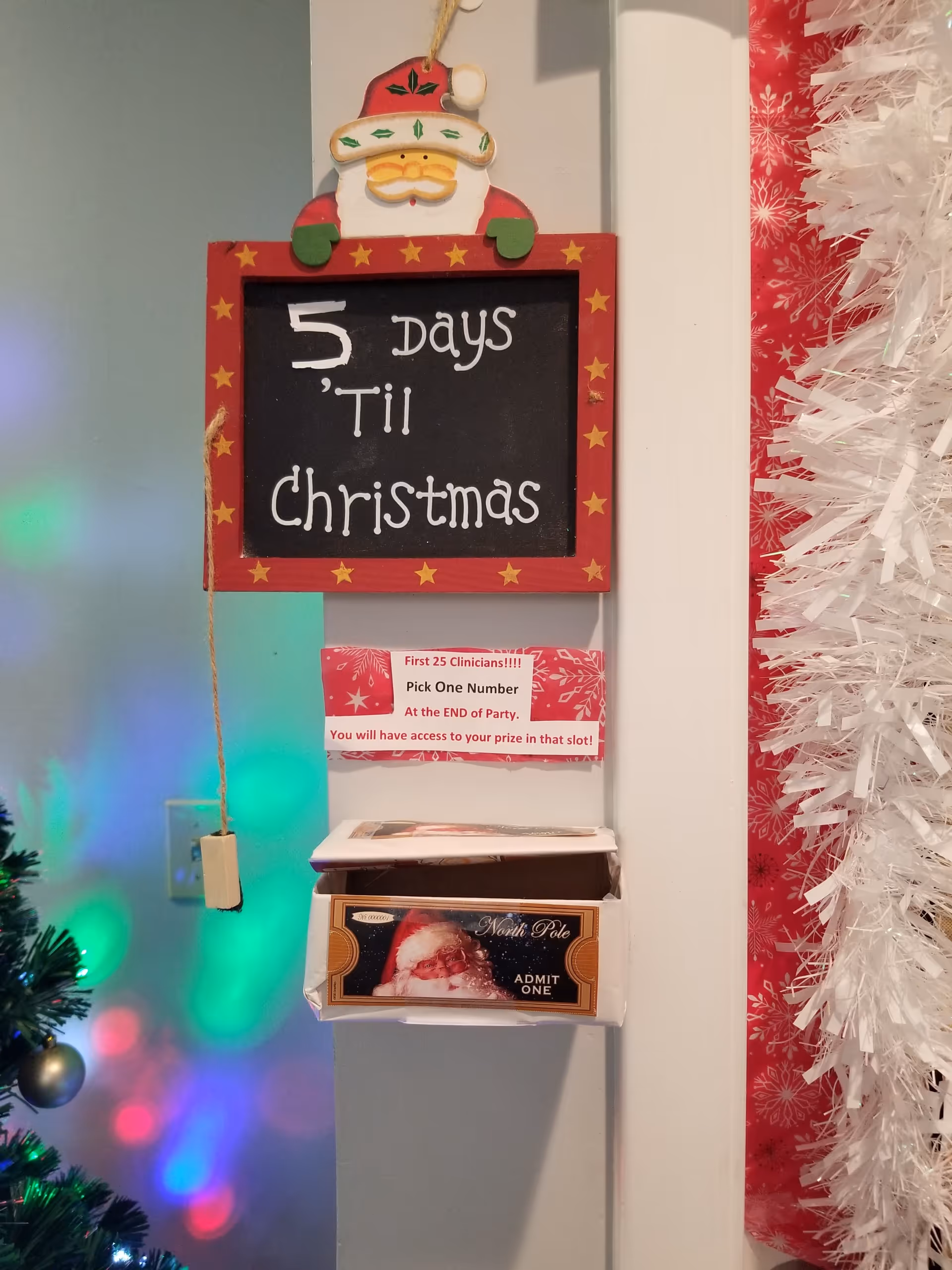 Holiday display featuring a chalkboard sign '5 Days Til Christmas' with Santa on top.