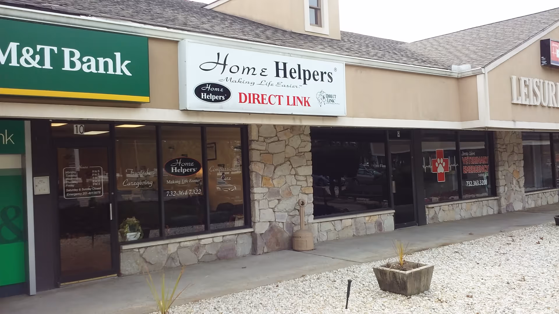 Exterior storefront view with Home Helpers & Direct Link signage on a strip mall.