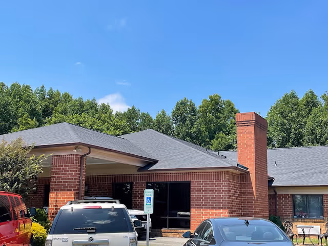 Exterior view of Lakewood Care Center featuring a brick building and cars in the parking lot.