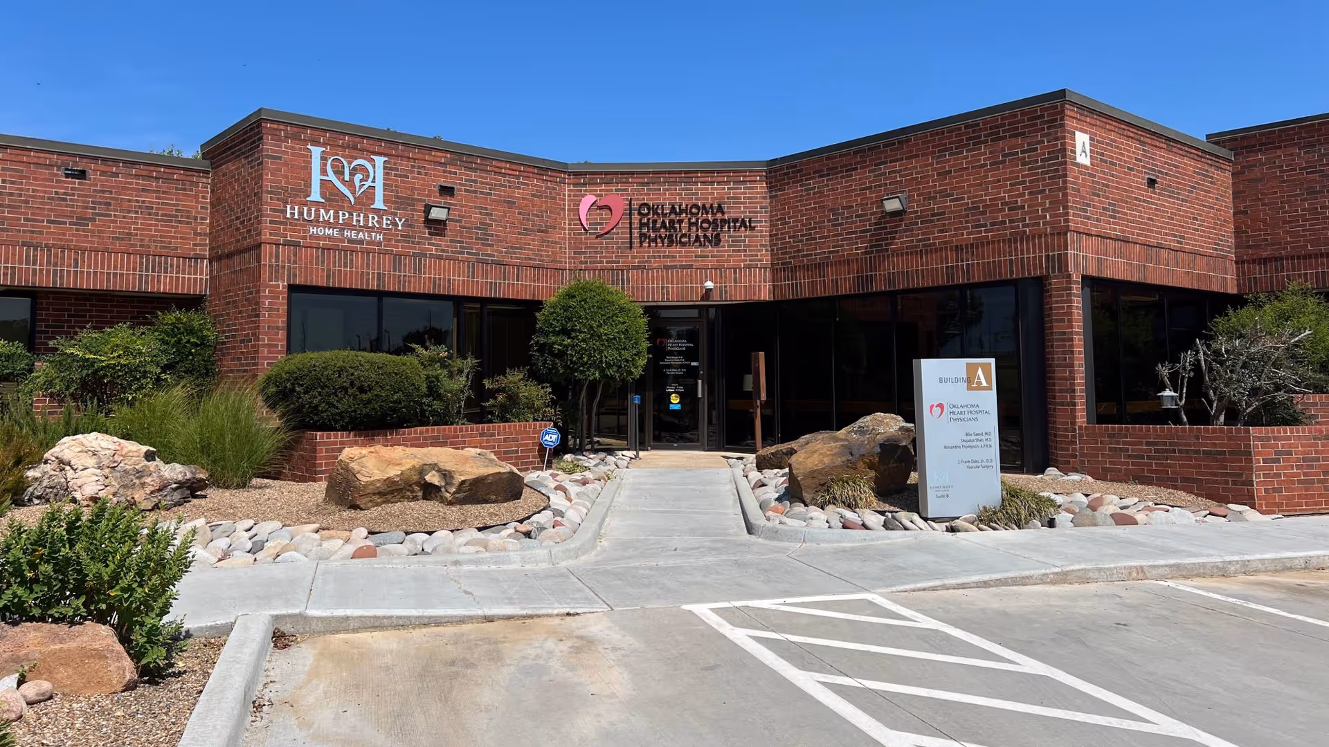 Brick building exterior with Humphrey Home Health signage, glass entrance, and landscaped front.