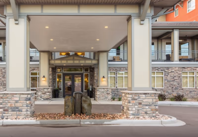 Exterior view of Affinity at Puyallup entrance with a covered canopy and stone facade.