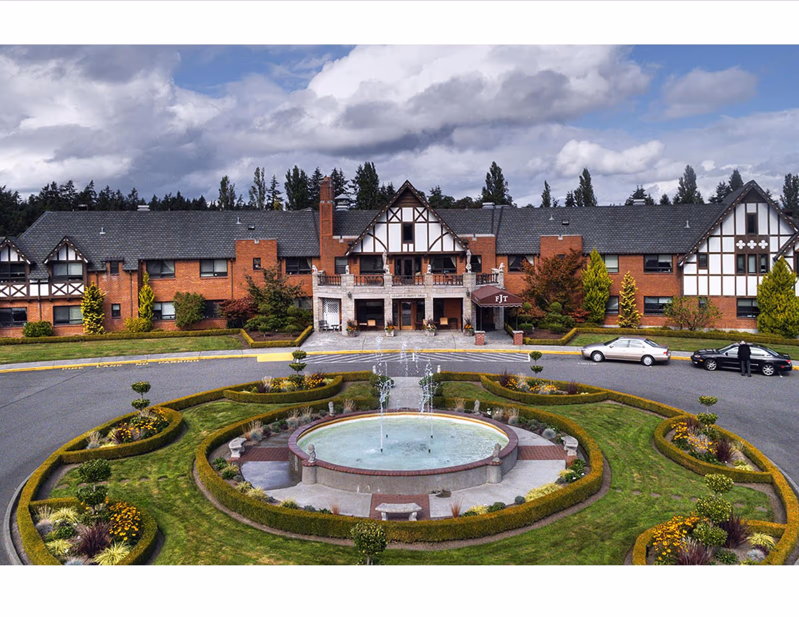Front view of Franke Tobey Jones facility with a circular fountain and landscaped gardens.