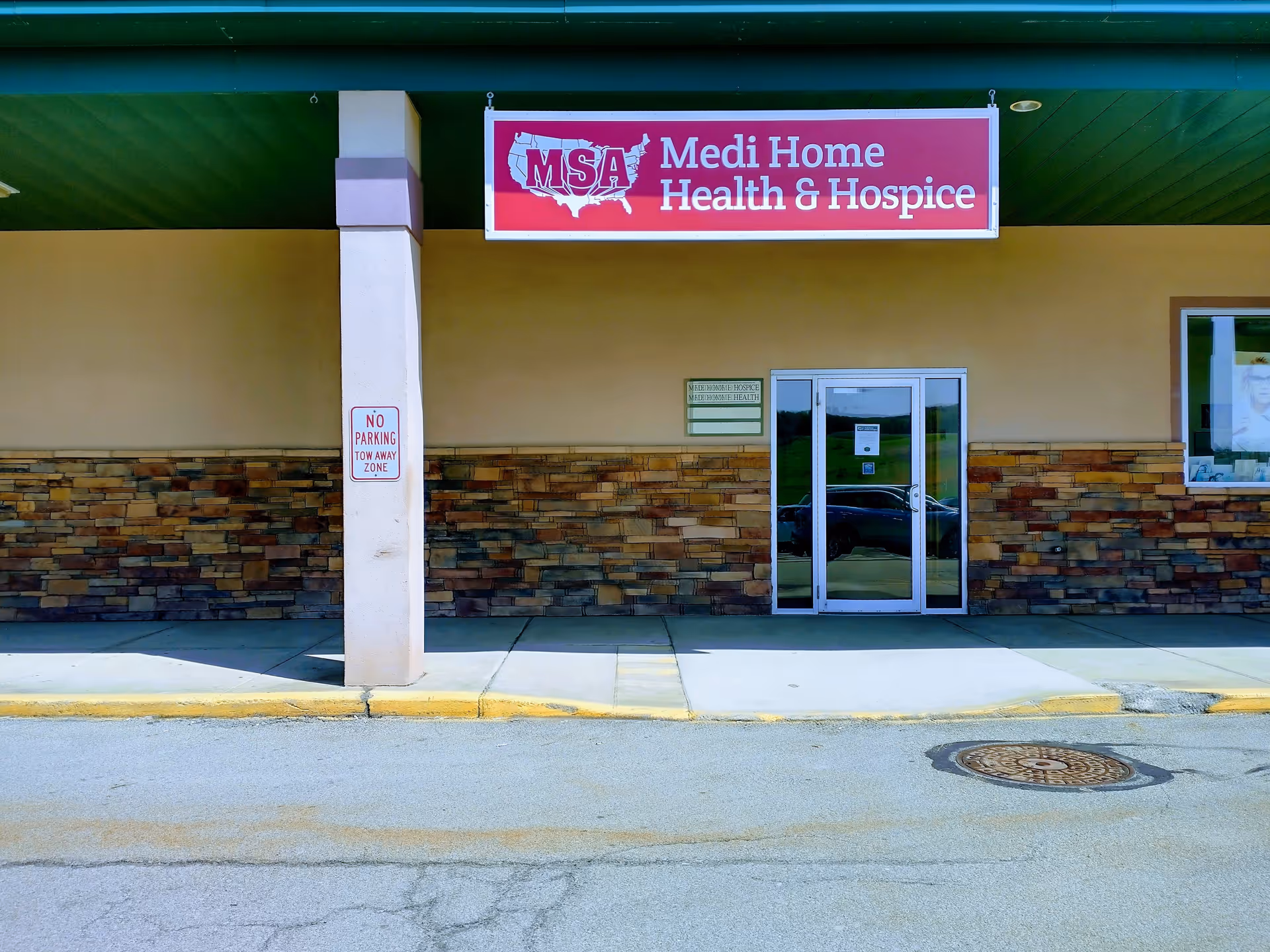 Exterior view of Medi Home Health and Hospice facility with entrance and sign.