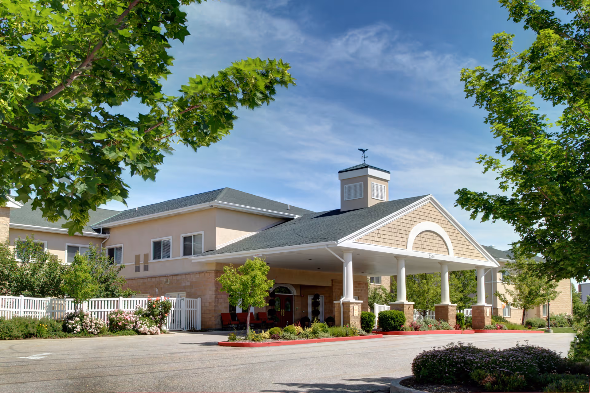 Legacy House Assisted Living of Ogden entrance with covered portico and landscaped front yard.