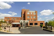 Brick Townview Health and Rehabilitation Center exterior with entrance, parking lot, and clear blue sky.