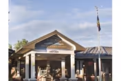Front view of Idaho State Veterans Home Boise entrance with flagpole