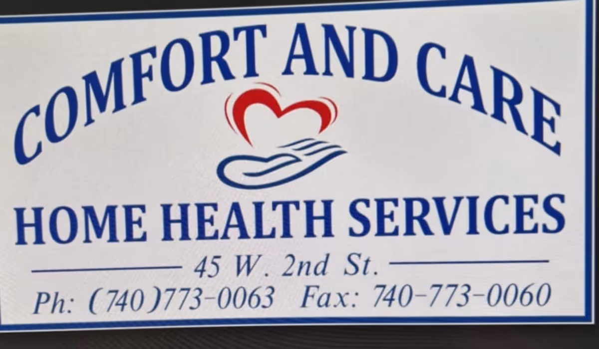 A front sign for Comfort And Care Home Health Services with a heart-and-hands logo.