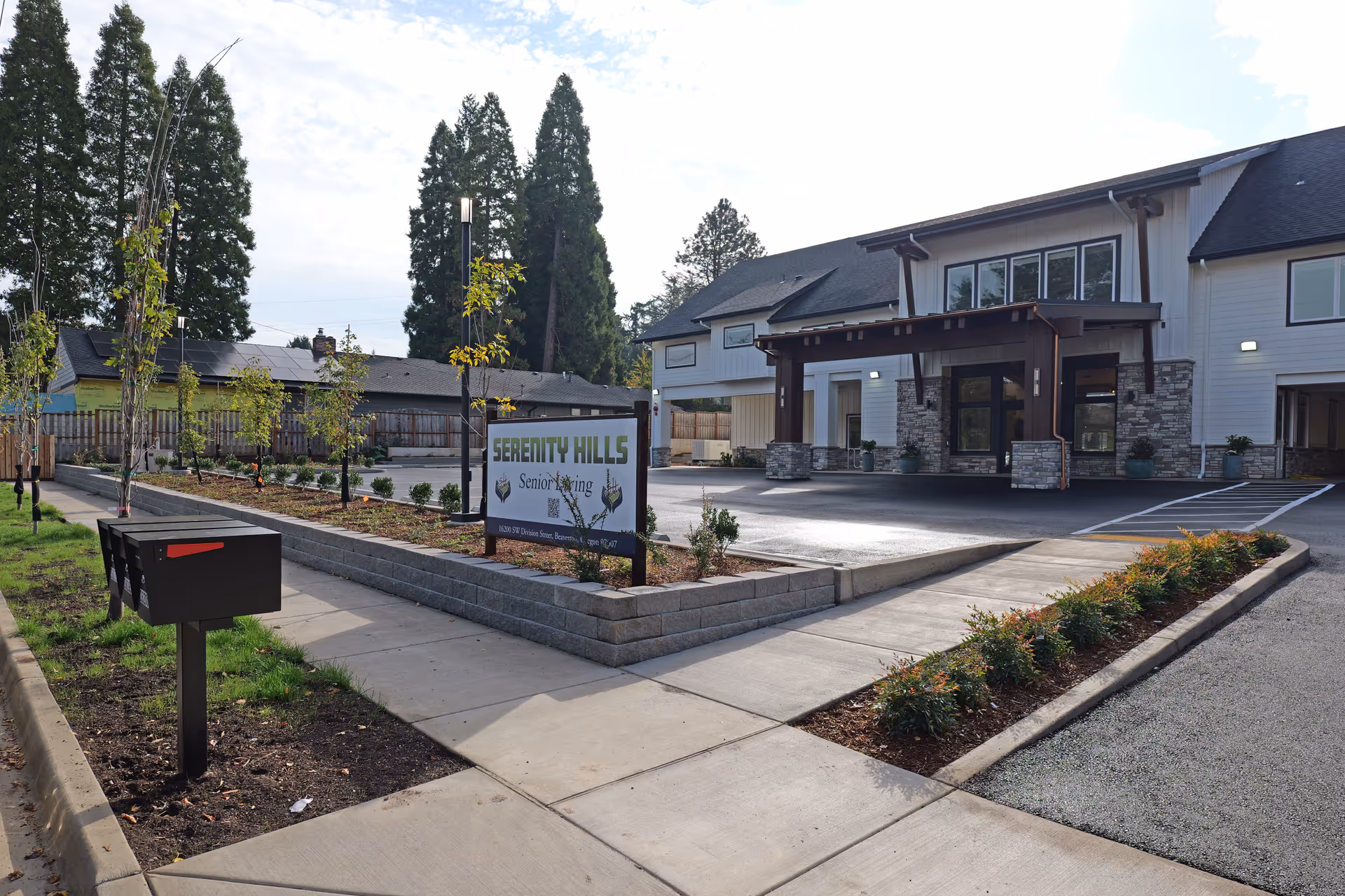 Exterior view of Serenity Hills Senior Living building with entrance and surrounding landscaping.