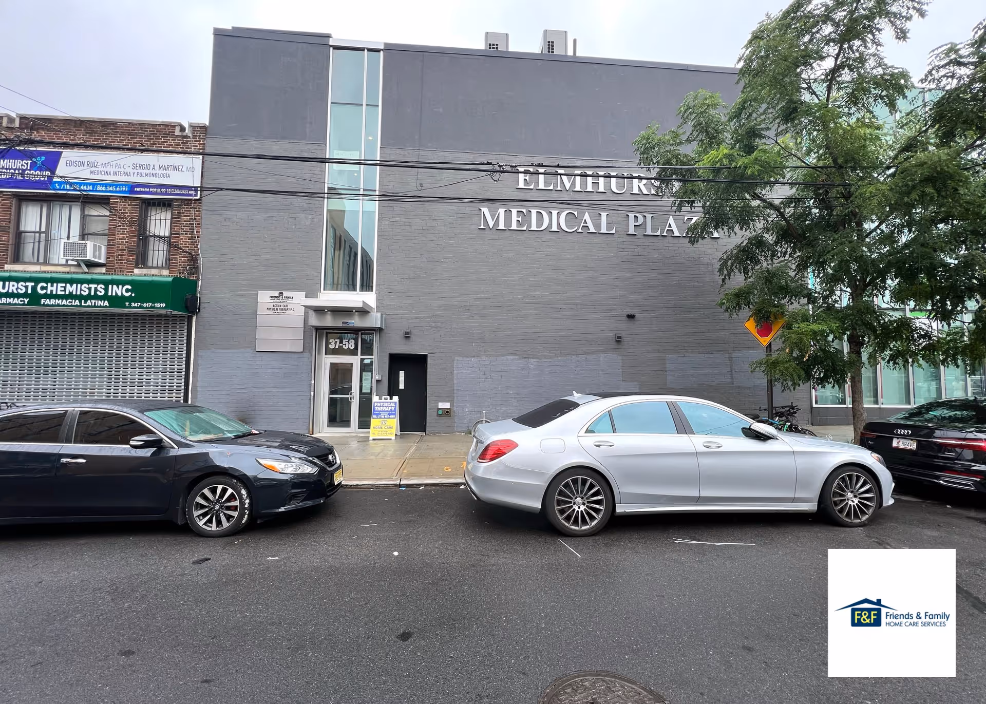 Front exterior of Elmhurst Medical Plaza with parked cars along the street.