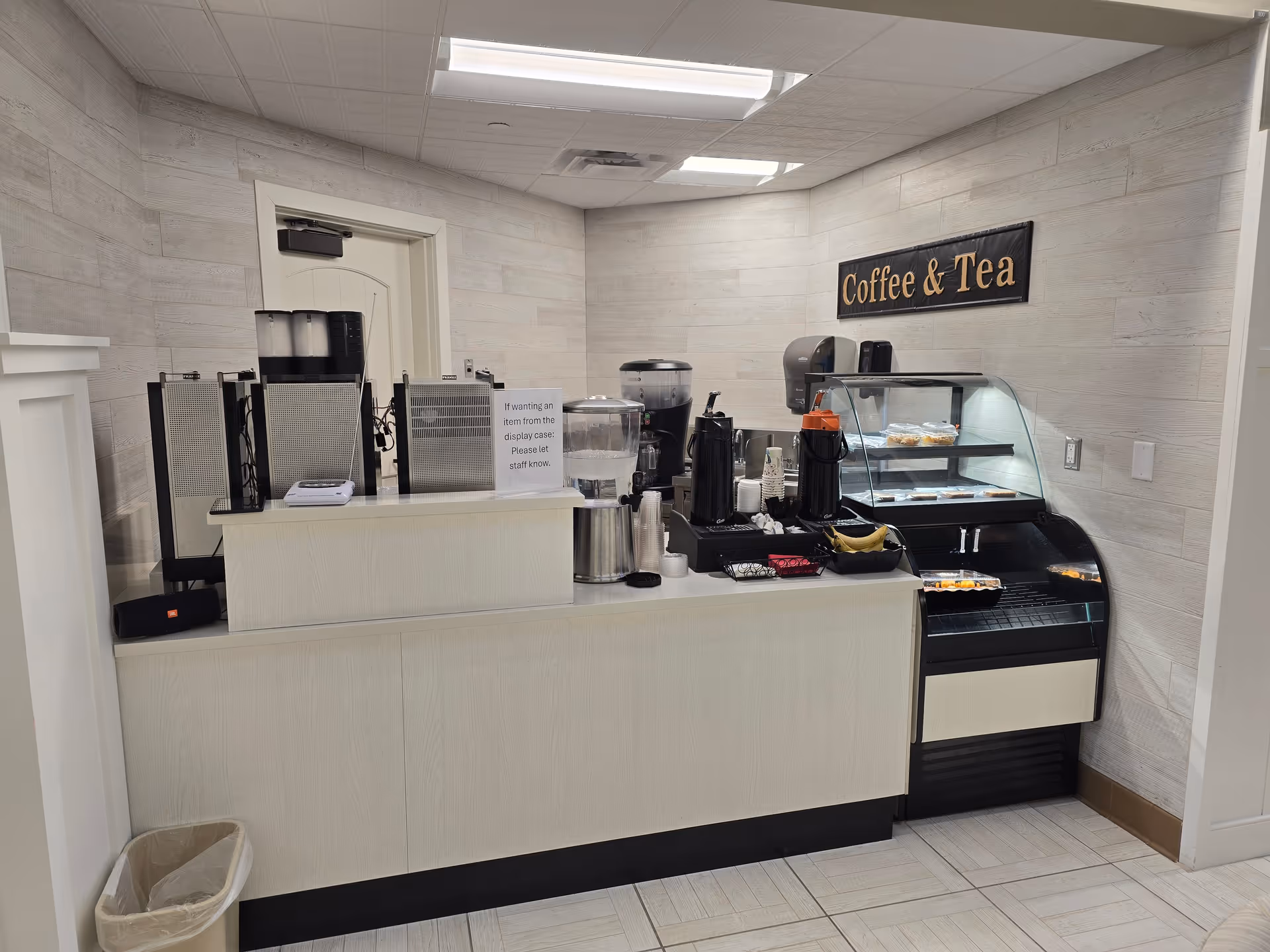 Indoor coffee bar with machines and pastry display at Meadow Place Assisted Living.