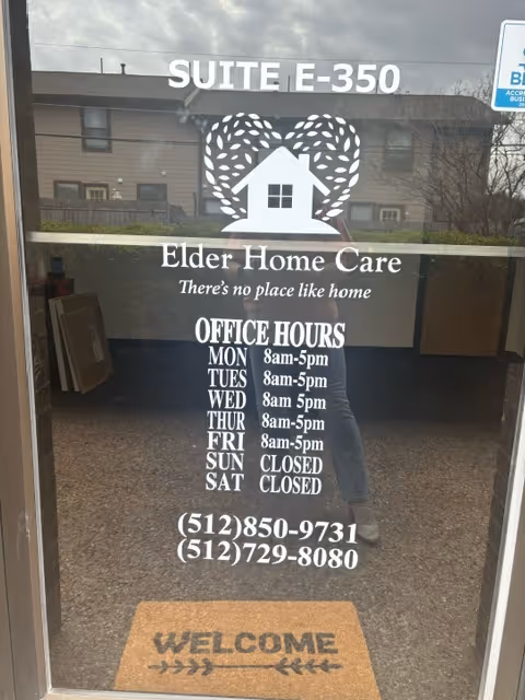 Front entrance of Elder Home Care with hours and logo on glass.