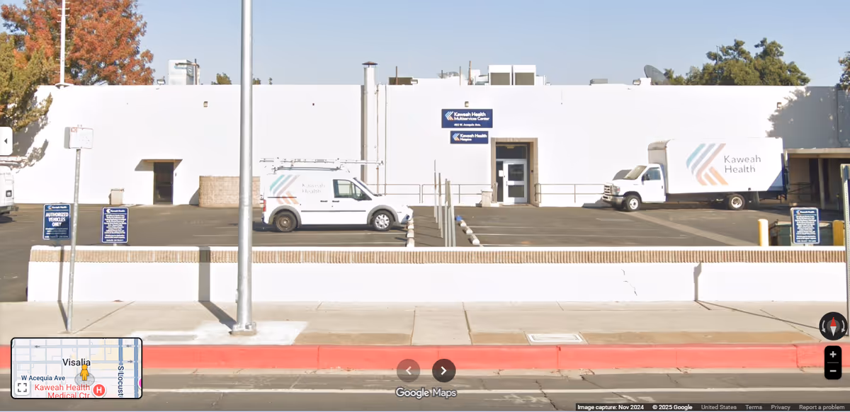 White Kaweah Health Home Health building front with two delivery trucks parked outside.