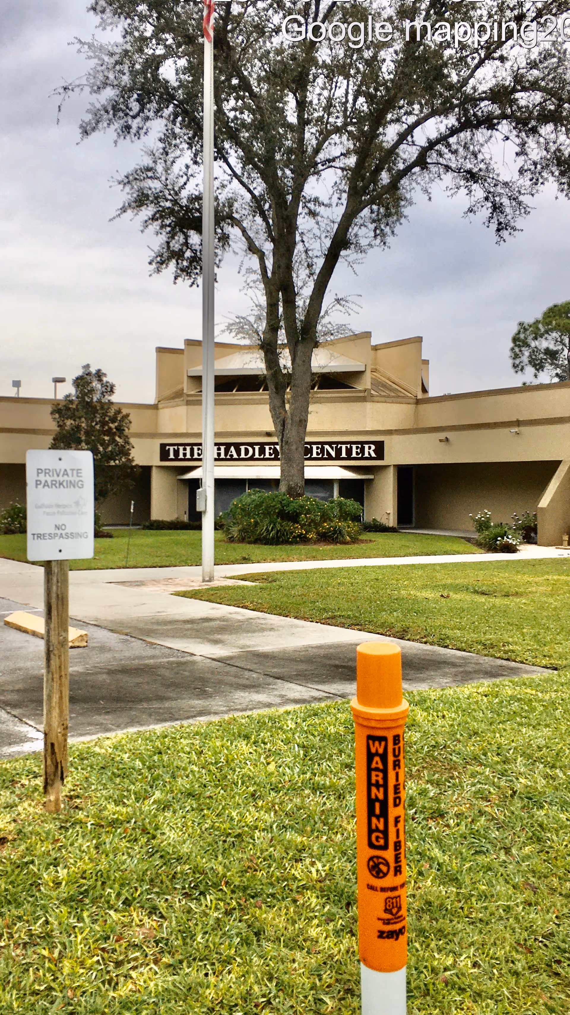 Exterior view of The Hadley Center entrance with tree and lawn.