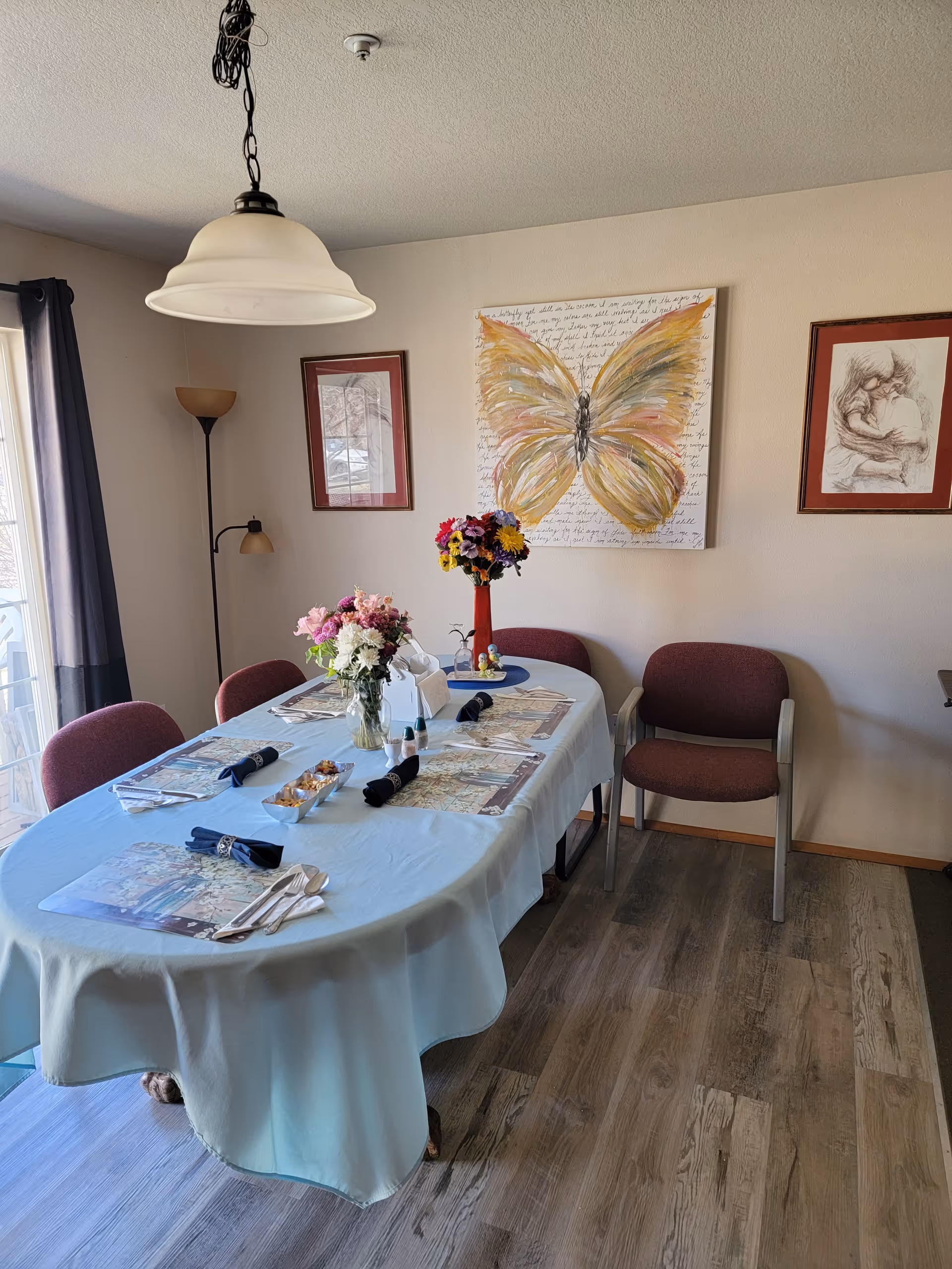 Dining room at a senior facility with a long table set for guests.