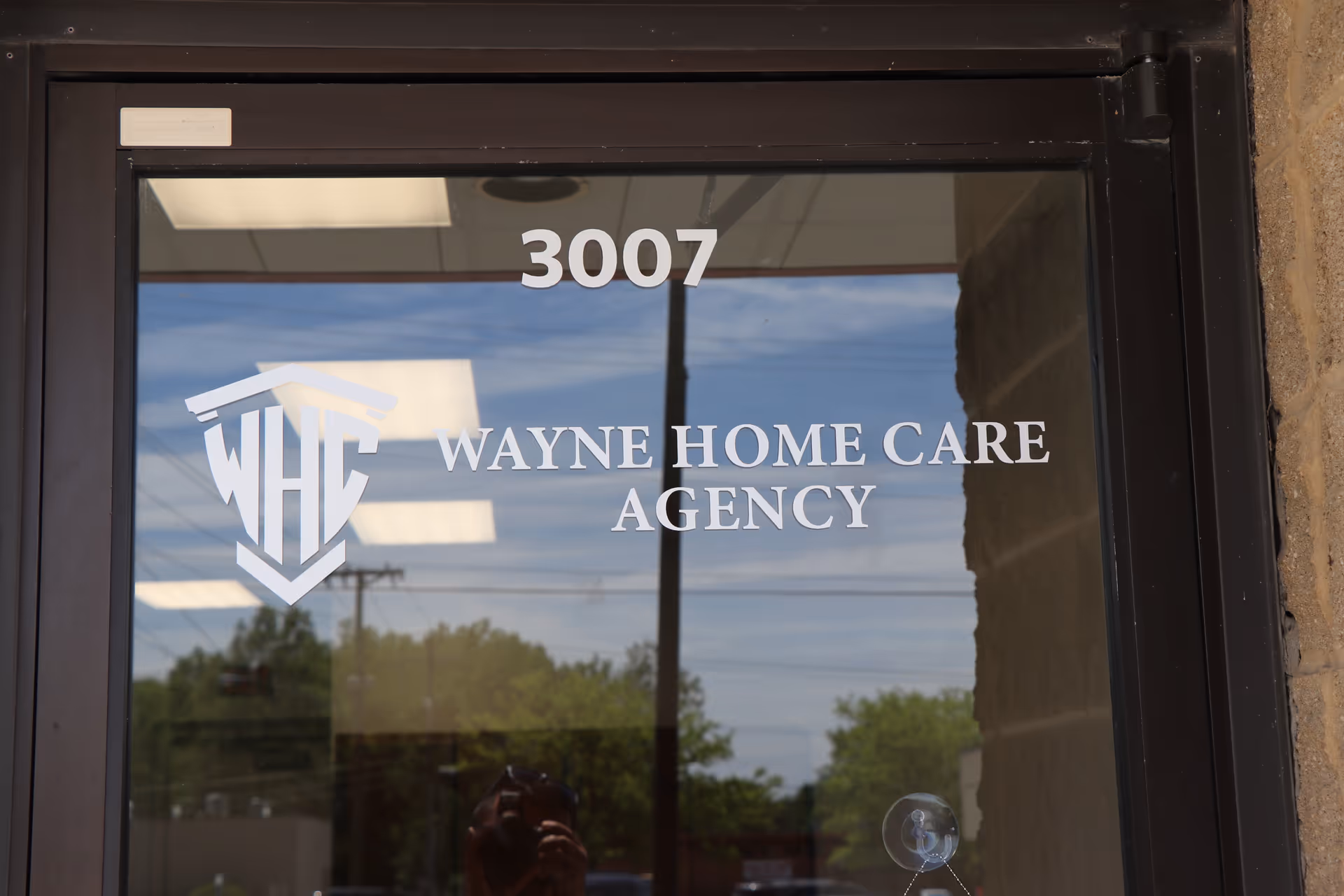 Glass door with Wayne Home Care Agency logo and the number 3007.