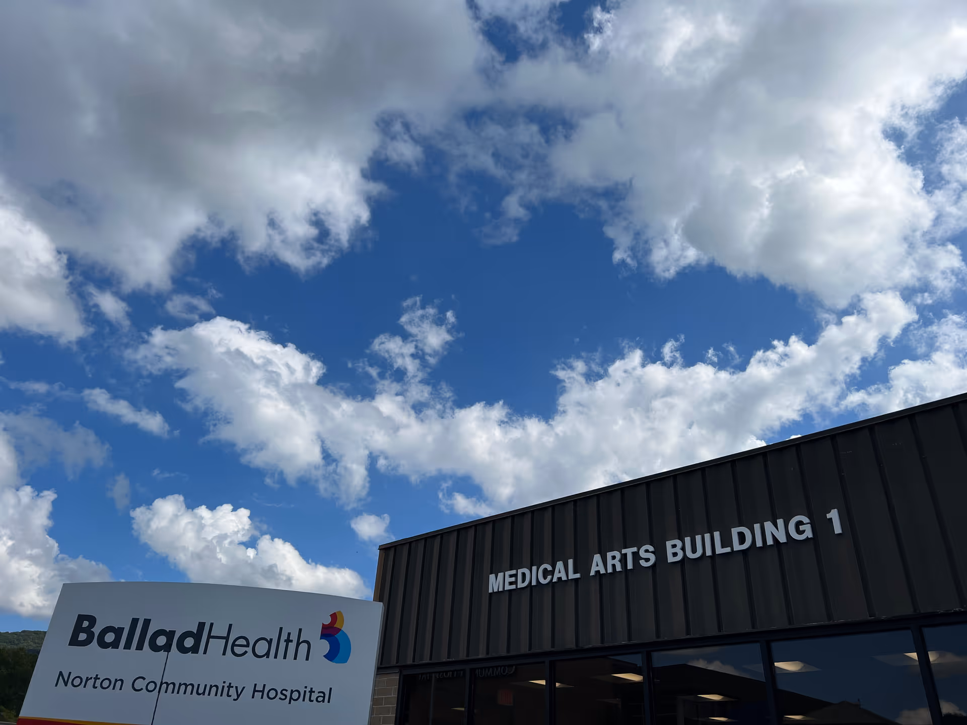 Exterior view of Ballad Health Medical Arts Building against blue sky.