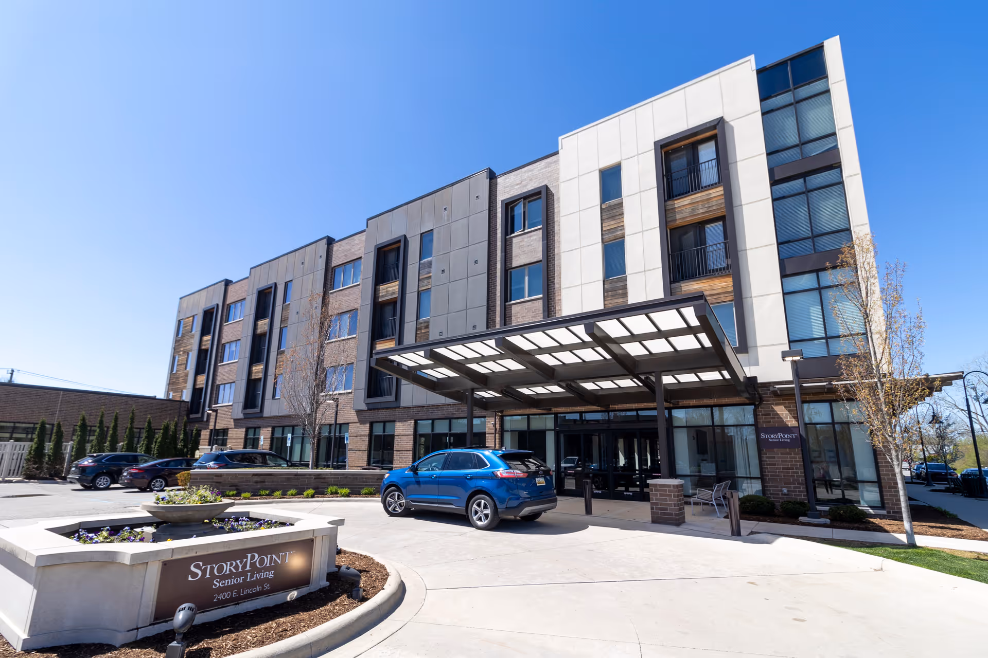 Front exterior of a StoryPoint Birmingham senior living building with a covered entrance