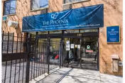 Brick building entrance with a blue canopy reading The Phoenix Rehabilitation & Nursing Center.