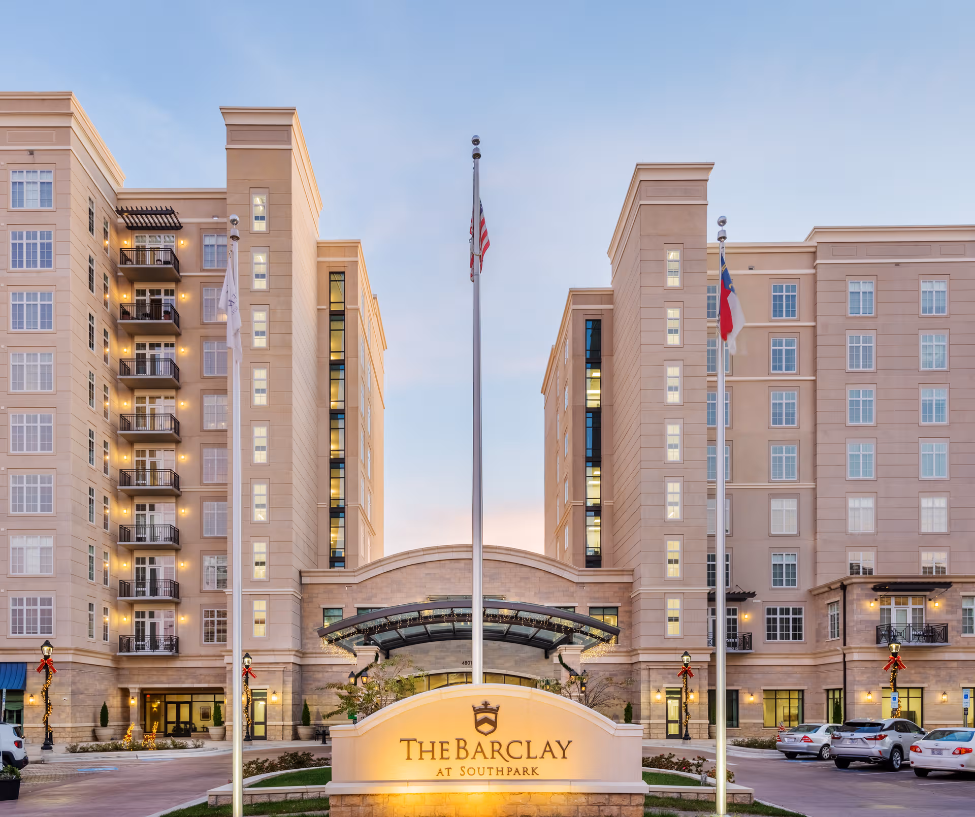 The Barclay at SouthPark exterior entrance with flags and illuminated sign.