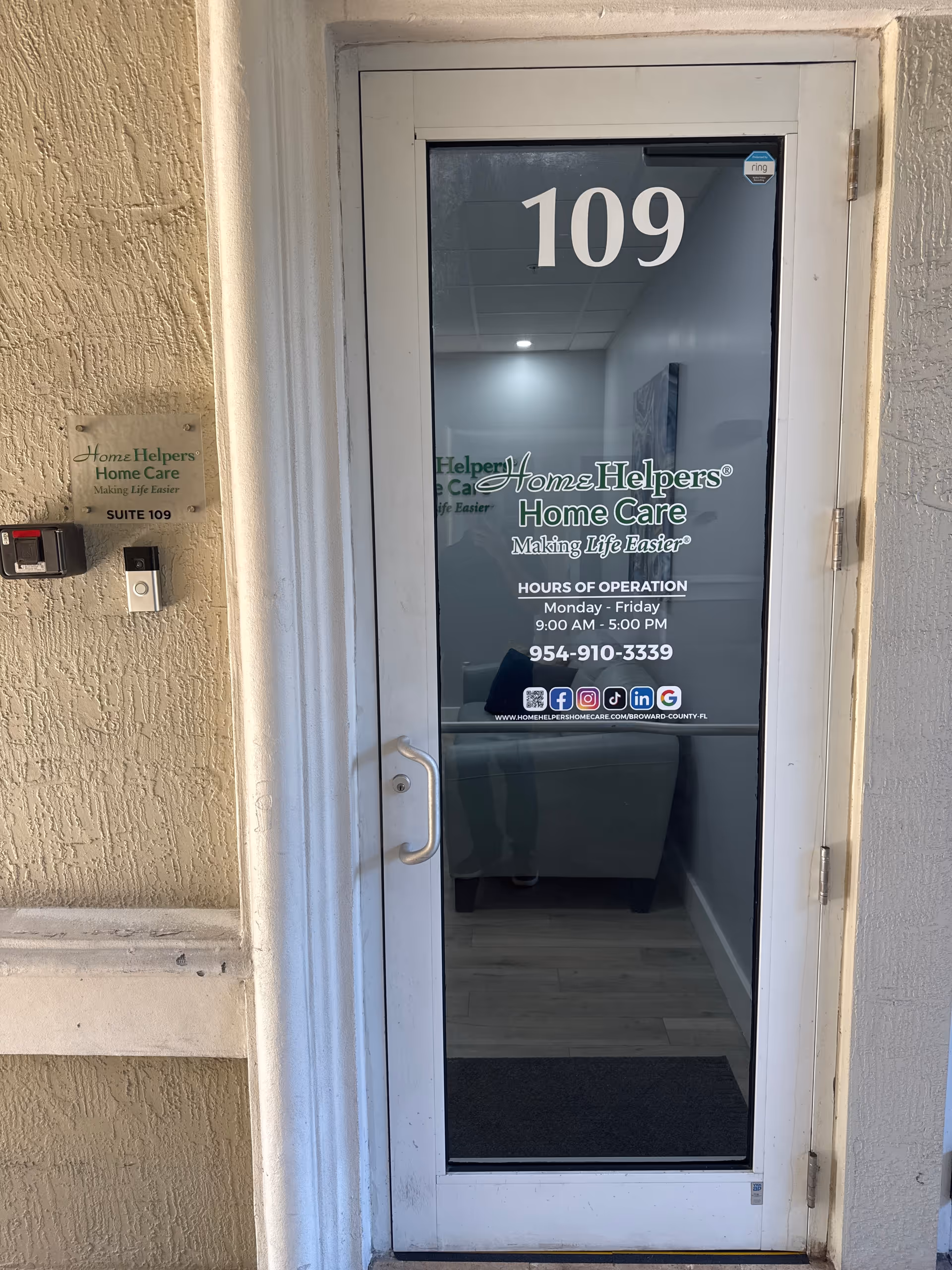 Glass door marked 109 with Home Helpers Home Care signage on a beige exterior wall.