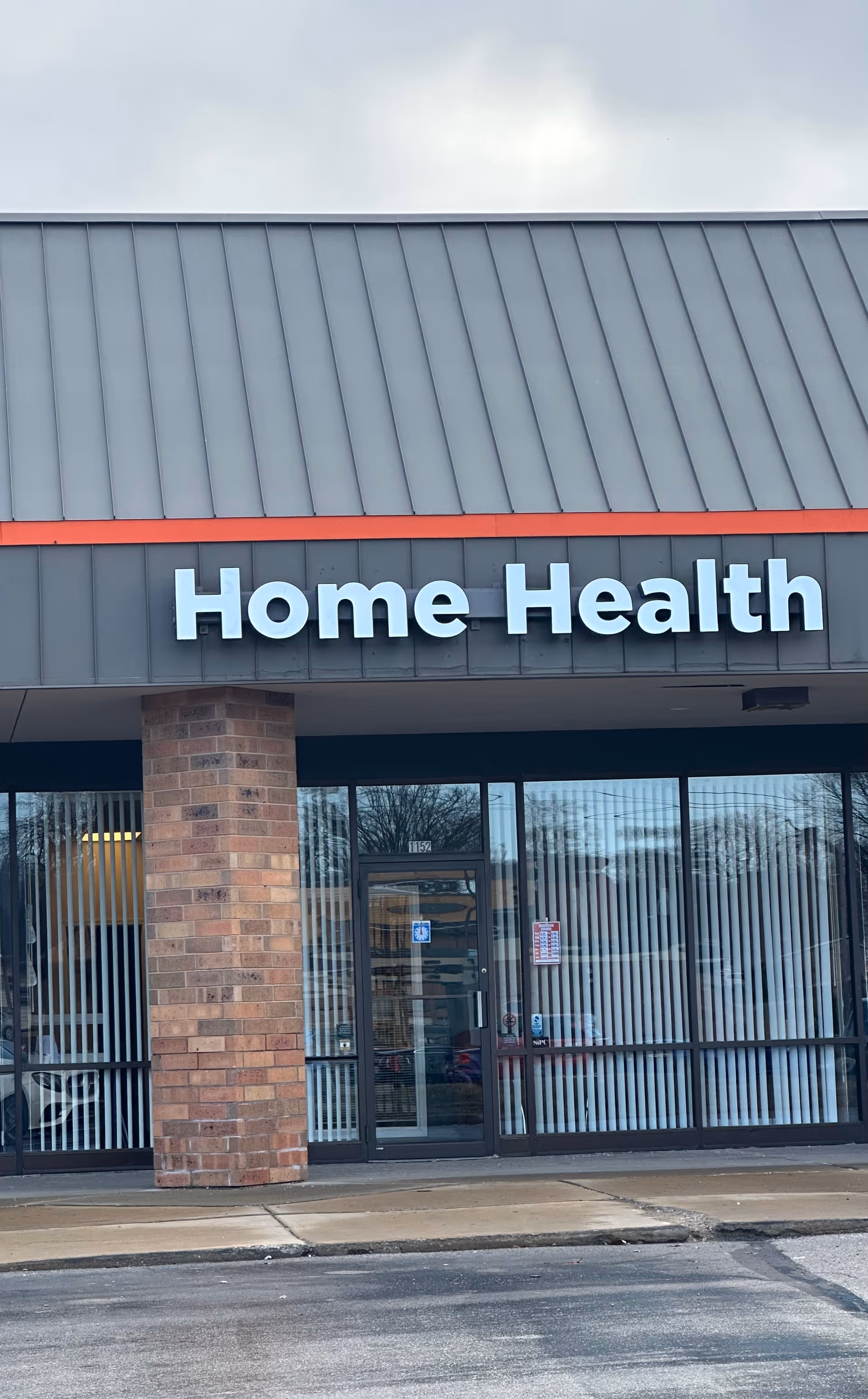 Exterior storefront of PCS Home Health Inc with large 'Home Health' sign and glass doors.