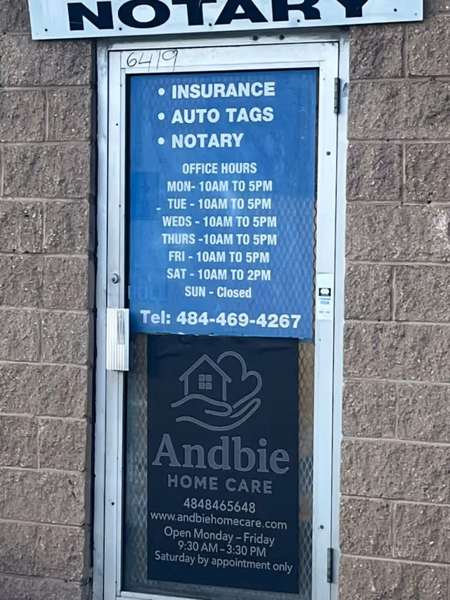 Door signage displays Andbie Home Care with hours and services on blue panel.