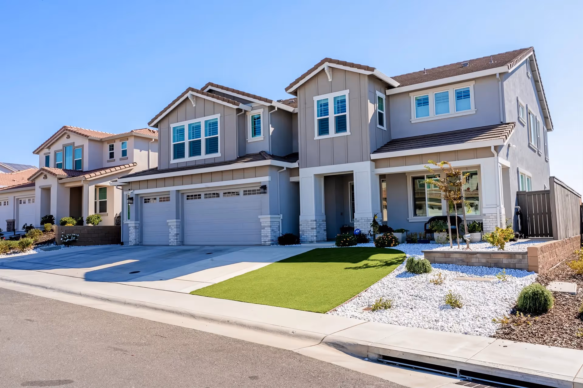 Modern, two-story senior living homes with attached garages and neatly landscaped front yards.