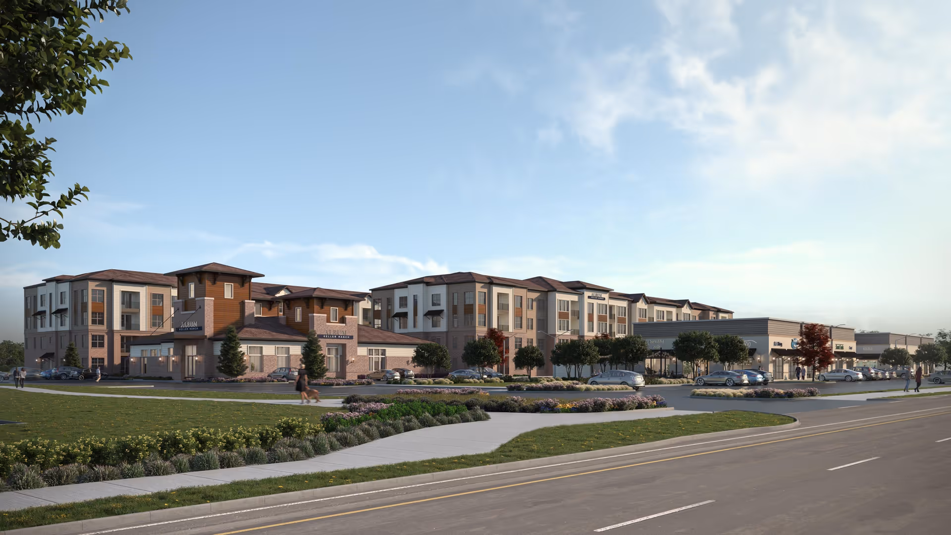 Exterior view of Album Keller Ranch facility showing a large multi-story building with a combination of brick and siding, surrounded by landscaped greenery, trees, parked cars, and a sidewalk along a road. People are walking near the entrance and around the property.