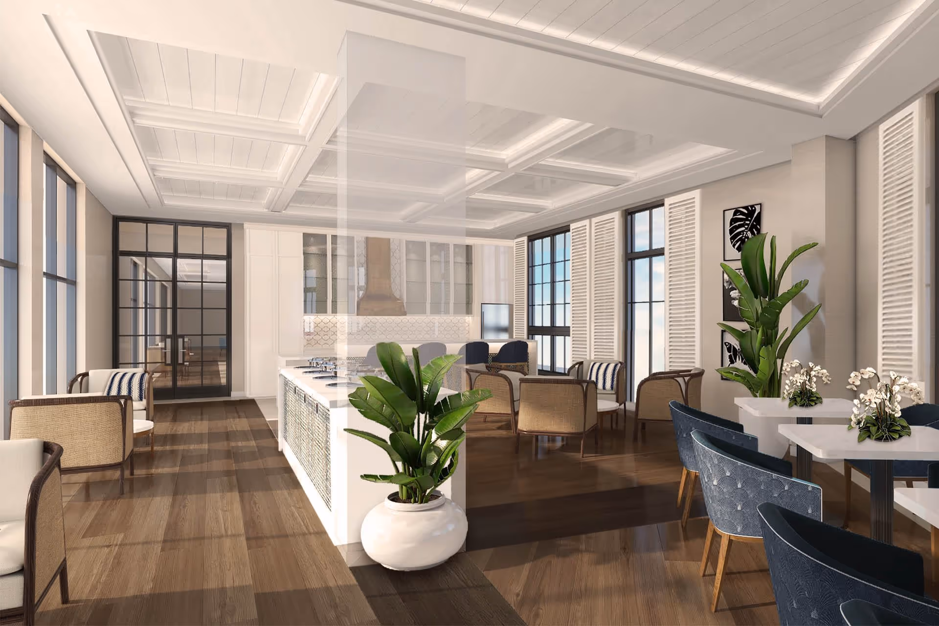 A spacious, modern interior featuring a kitchen island with a stove and seating, surrounded by various seating areas including wicker chairs and blue upholstered chairs at tables. Large windows with white shutters allow natural light to fill the room, and there are several green plants and framed artwork on the walls. The ceiling has a coffered design with recessed lighting, and the floor is a polished wood.
