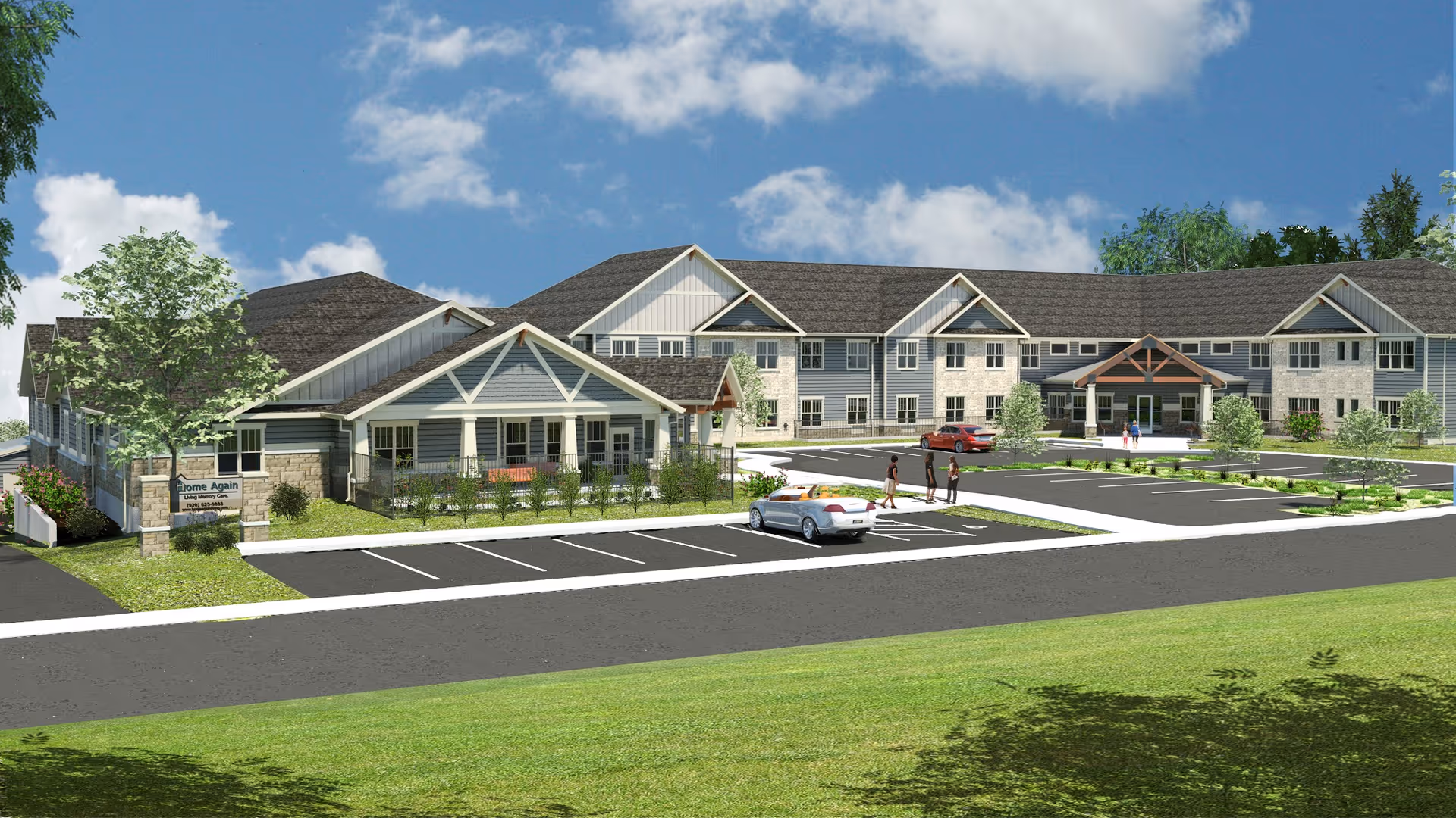 Exterior view of Home Again Assisted Living & Memory Care Waunakee facility showing a large two-story building with a covered entrance, parking lot with cars, landscaped greenery, and a clear blue sky with some clouds.