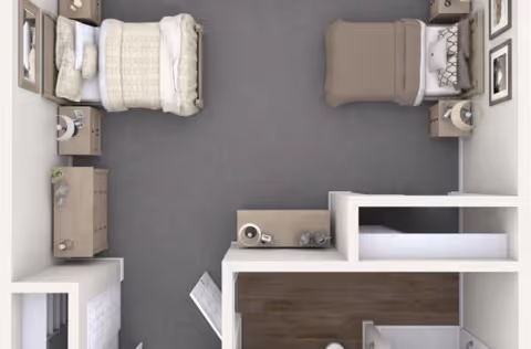 Top-down view of a shared bedroom with two beds, each with bedside tables and lamps. The room has a dresser, a small desk, and framed pictures on the walls. The floor is carpeted and there is a small hallway leading to a bathroom area.