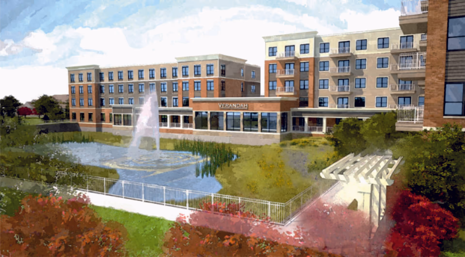 Exterior view of Verandah Retirement/Senior Living Community showing a multi-story building with balconies, large windows, a water fountain in a pond, landscaped greenery, and a white pergola structure.