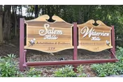 Wooden signs for Salem Hills Rehabilitation & Healthcare and Waterview Hills Rehabilitation & Healthcare mounted on purple posts surrounded by greenery and trees in the background.